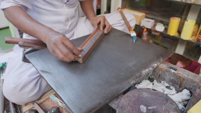 Young Indian Muslim man making colorful bangles, Jaipur, Rajasthan, India