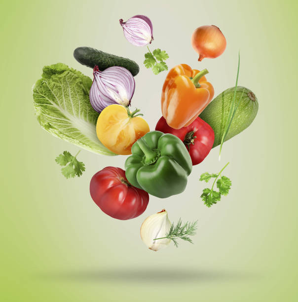 istock Many fresh vegetables and herbs falling on light green background 1644779744