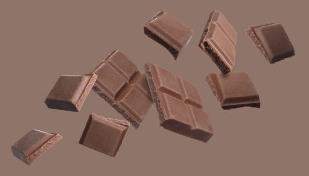 istock Pieces of chocolate bar falling on brown background 1644780525