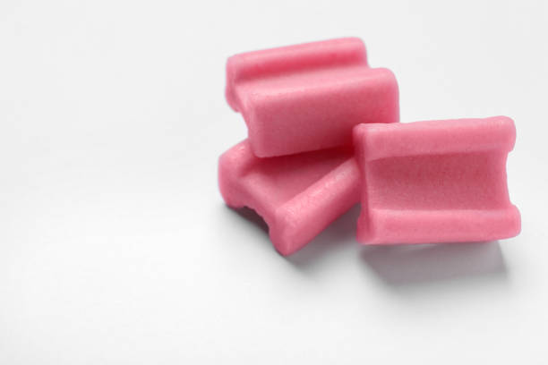 istock Tasty pink chewing gums on white background, closeup. Space for text 1644782196