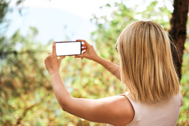 blonde beautiful woman taking landscape