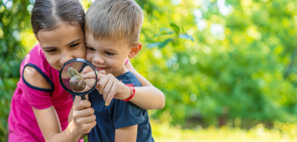 istock The child looks at the snail nature. Selective focus. 1644782798