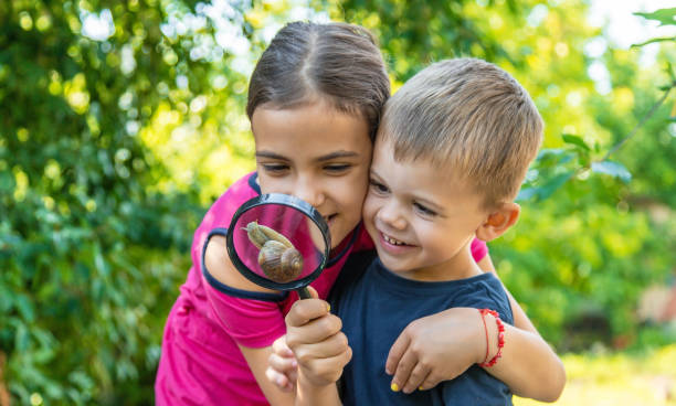 istock The child looks at the snail nature. Selective focus. 1644782913