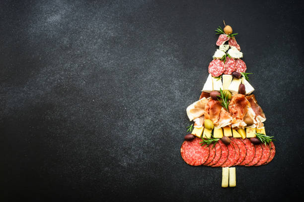 istock Cheese and meat with olives and holidays decorations. 1644783906