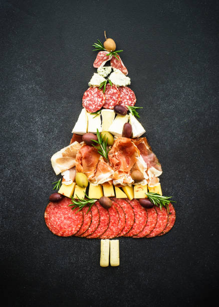istock Cheese and meat with olives and holidays decorations. 1644783911
