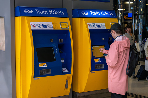Amsterdam, The Netherlands - 8 September 2022: Passenger buys ticket in the Central railway station in Rotterdam