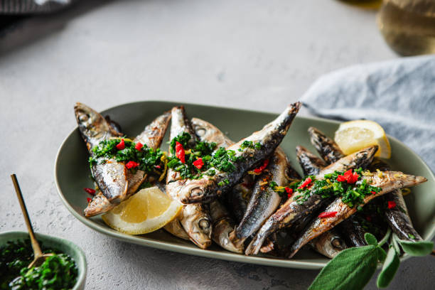 istock Plate of sardines with lemon on dining table 1644843790