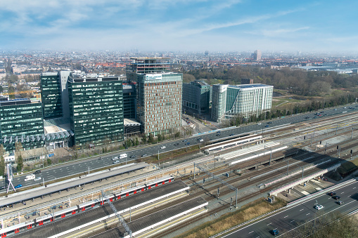 Amsterdam, The Netherlands-April 2022; High angle view of highway and train tracks and public transit exchange on Zuidas financial district