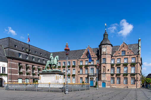 Dusseldorf, Germany-April 2022; View over the market square in the Old Town of the city with historic town hall and bronze statue in the center of John William, one of the founders of the city