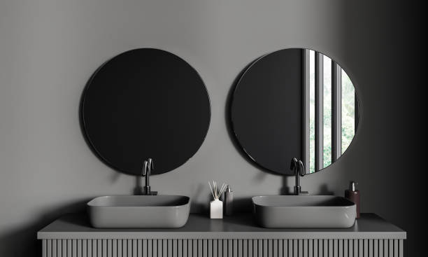 istock Grey bathroom interior with double sink and mirror, accessories on deck 1644851329