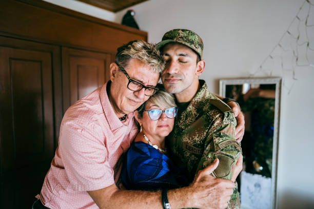 istock Soldier embracing parents at home 1644853980