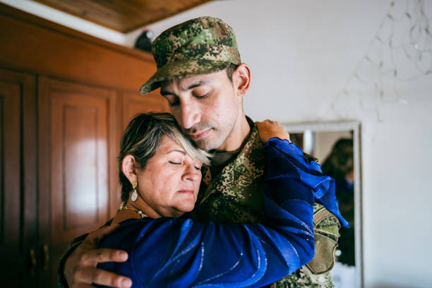 istock Soldier embracing his mother at home 1644854001