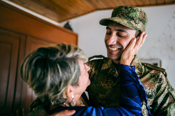 istock Soldier embracing his mother at home 1644854010