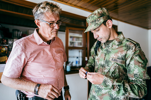 Army soldier receiving a gift of his father at home