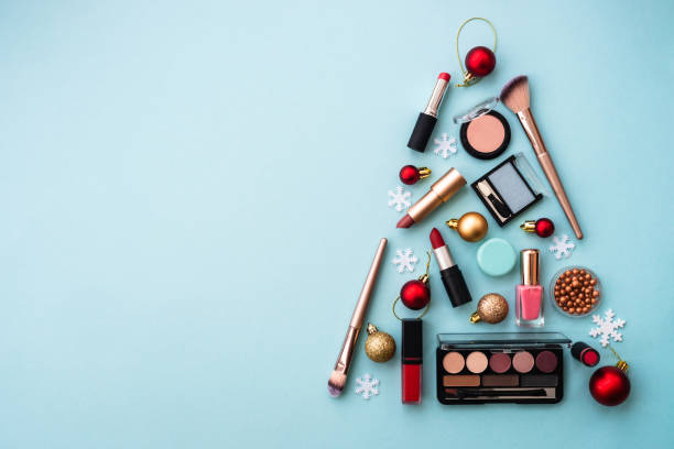 istock Christmas tree made from cosmetic and make up products on blue. 1644867097