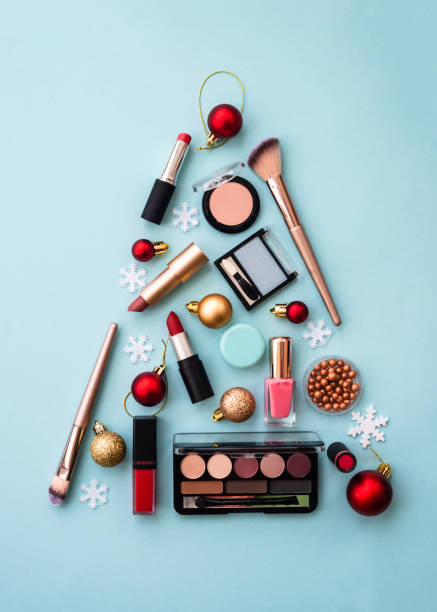 istock Christmas tree made from cosmetic and make up products on blue. 1644867637
