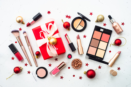 Make up and cosmetic products and christmas decor on white. Christmas sale and gift concept. Flat lay image with copy space.