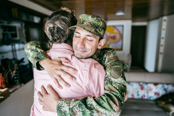 istock Soldier embracing his father after his return/or leaving home 1644871575
