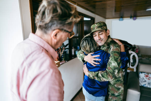 istock Soldier embracing his mother after his return/or leaving home 1644871579