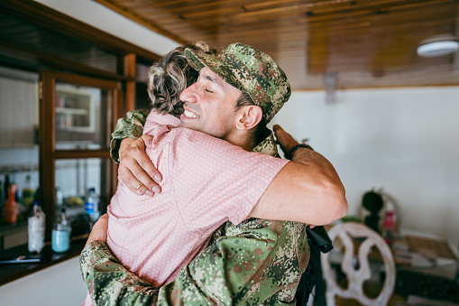 Soldier embracing his father after his return home