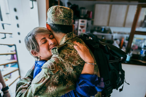 istock Senior woman embracing her soldier son that returned home 1644872100