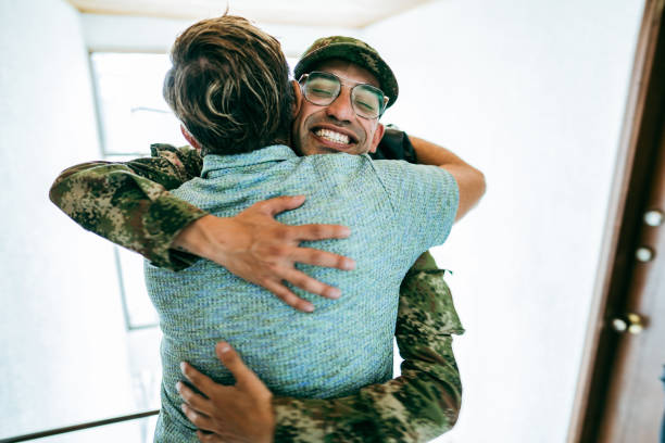 istock Soldier embracing his father after his return home 1644872639
