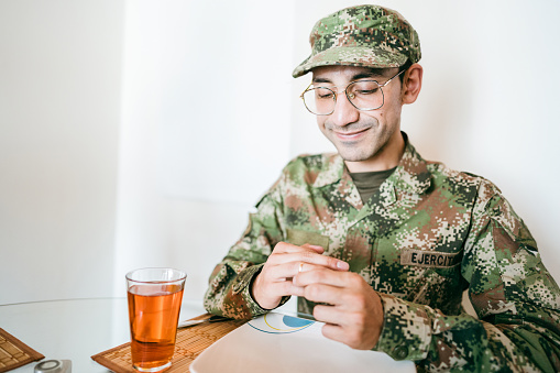 Army soldier caressing or touching his wedding ring and lunch at home