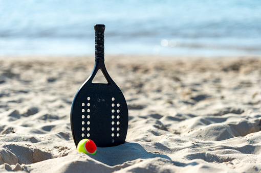 Racket and ball on the sandy beach. Summer sport concept. Horizontal sport theme poster, greeting cards, headers, website and app
