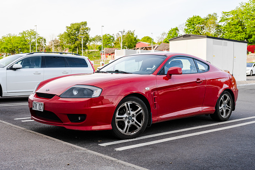 Gothenburg, Sweden - May 19 2023: Red 2005 Hyundai Coupe 2.7 V6 at a parking lot.