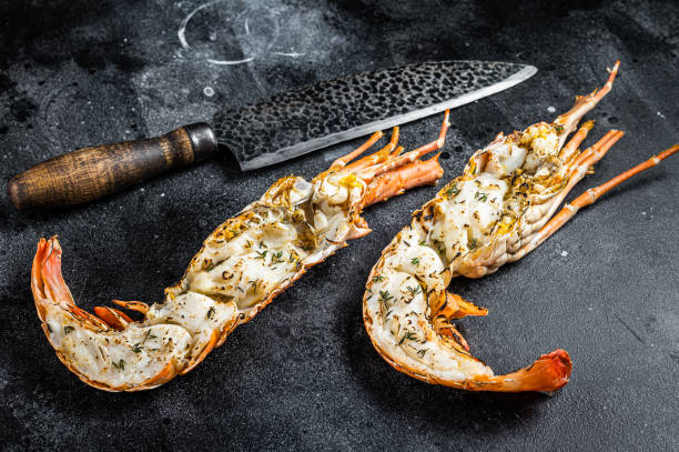 istock BBQ Grilled Spiny lobster sliced on a cutting board Black background. Top view 1644906162
