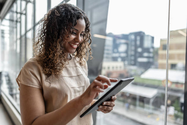 istock Mid adult woman working using digital tablet in the office 1644940248