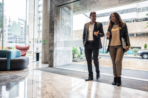 istock Coworkers talking as and arriving on the office 1644961199