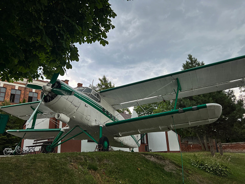 Propeller biplane aircraft type SP-ZEN - PZL-Mielec An-2 standing on the square in front of the Aviation Center of the State Academy of Applied Sciences in Chem, Poland.