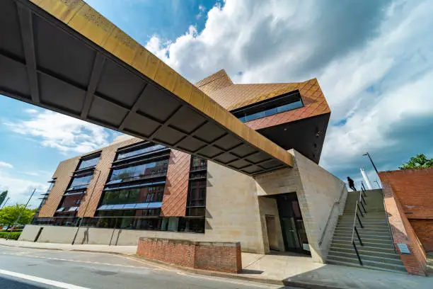 Dramatic modern architecture,center of further education and reading,for the public and university of Worcester students alike,a distinctive golden tiled city landmark,with large glass windows.