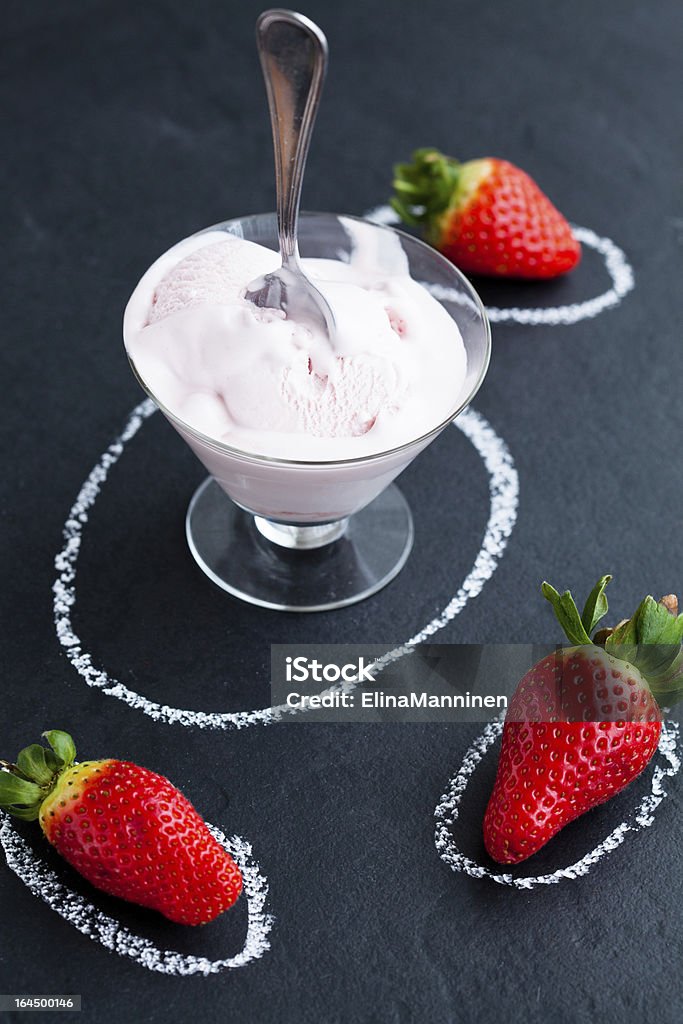 Strawberry ice cream and whole strawberries Strawberry ice cream in glass bowl and three whole strawberry on dark background Bowl Stock Photo