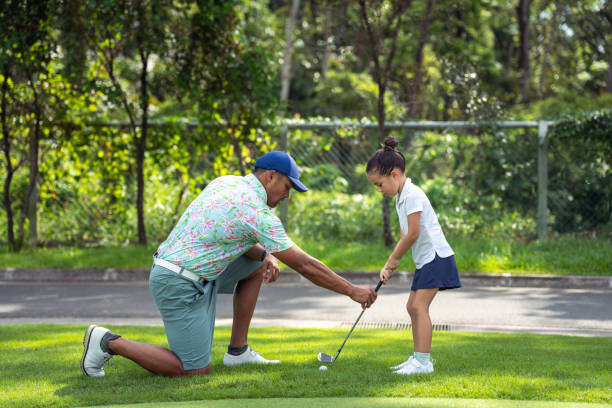 istock Golf professional coaches young girl 1645031817