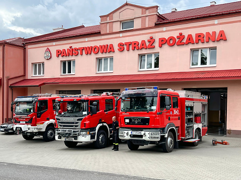 Chelm, Poland, July 21, 2023: Fire Brigade cars in Chem standing in front of the fire station with partially visible equipment.