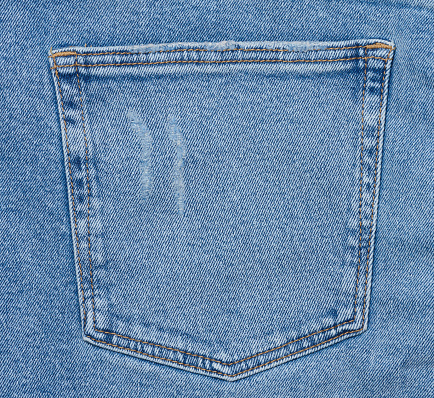 Back pocket of blue jeans, close up