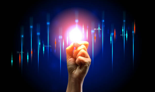 istock Holographic graph with growing indicators and a woman's hand with a marker on a blue background 1645066441