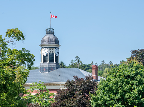 Clock on tower with Canadian flag