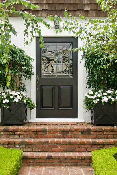 istock Traditional white cottage with black Dutch door 1645107062