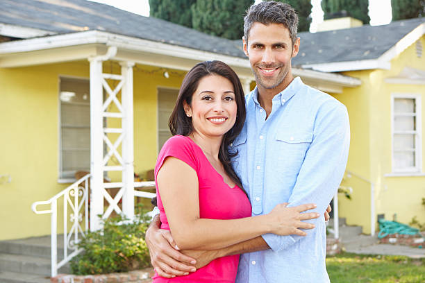 istock Couple Standing Outside Suburban Home 164517493