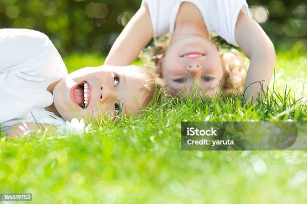 Happy Children Standing Upside Down Stock Photo - Download Image Now - Boys, Grass, Springtime