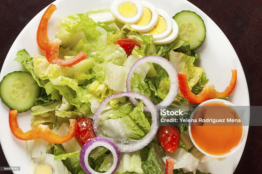 Green Salad Delicious green salad made with lettuce,cucumber,pepper,onios, and egg Appetizer Stock Photo