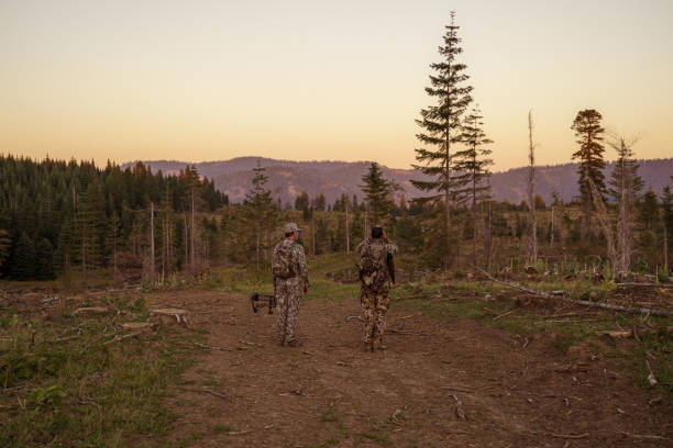 istock Two hunters hike on trail at dawn 1645200590