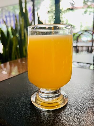 Glass of kombucha garnished with a slice of blood orange.\n\nKombucha is a fermented, lightly sparkling tea often consumed for its health benefits. it's made by fermenting sweetened tea with a probiotic culture of bacteria and yeast called a SCOBY.
