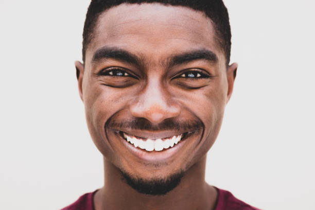 istock Close up young african American man smiling against white background 1645232487