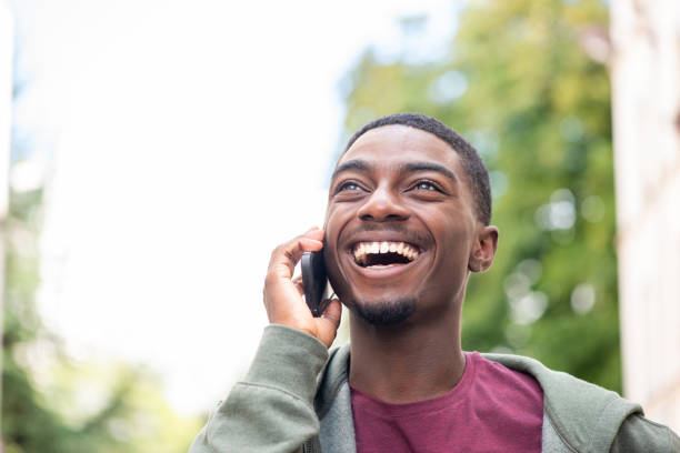 istock Close up happy young black man talking with cellphone 1645233007