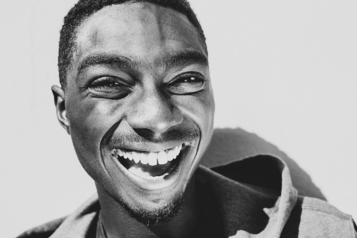 Close up black and white portrait laughing young african American man