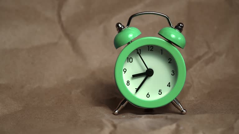 Hands of the Classic Alarm Clock Count the Time